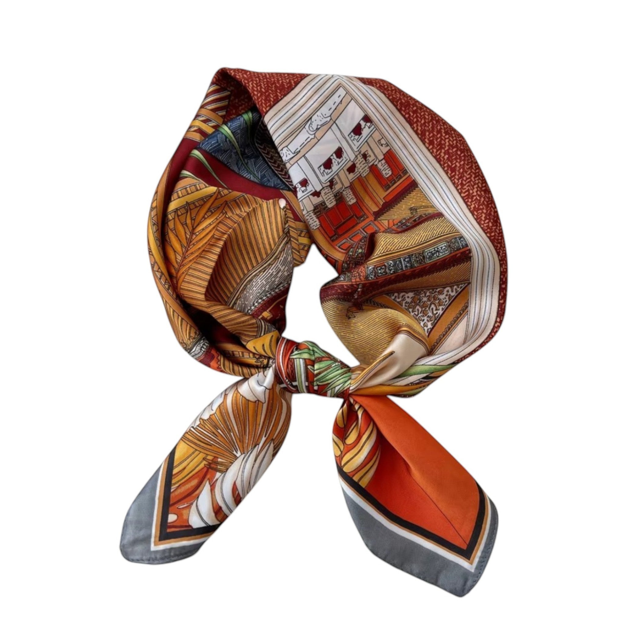 MiRA scarf i mjuk polyester med ett färgglatt blommönster och geometriska detaljer i orange och guldtoner.