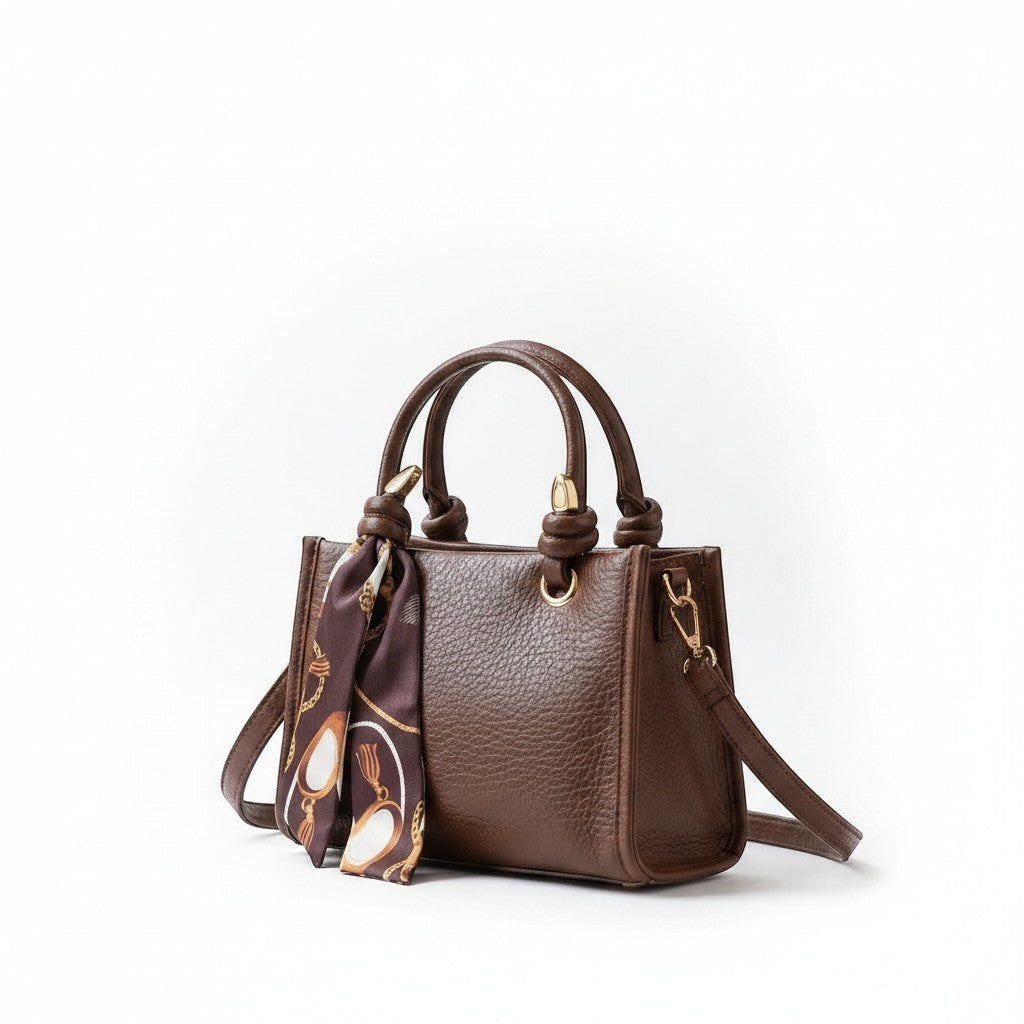 MiRA brun crossbody-väska i konstläder med handtag, axelrem och en dekorativ mönstrad scarf.