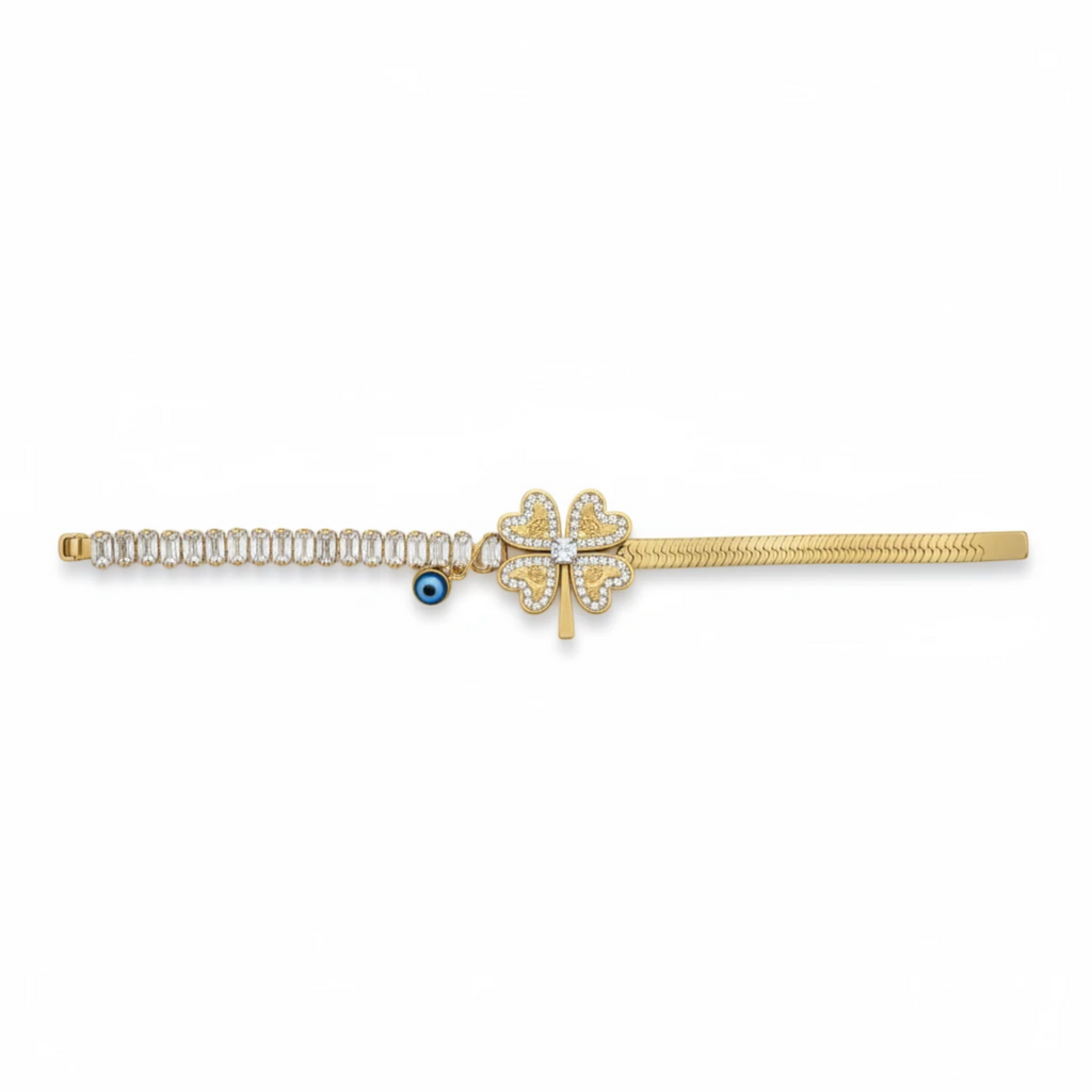 MiRA guldtonat armband i 316L rostfritt stål med fyrklöver, gnistrande stenar och en liten blå ögondetalj.