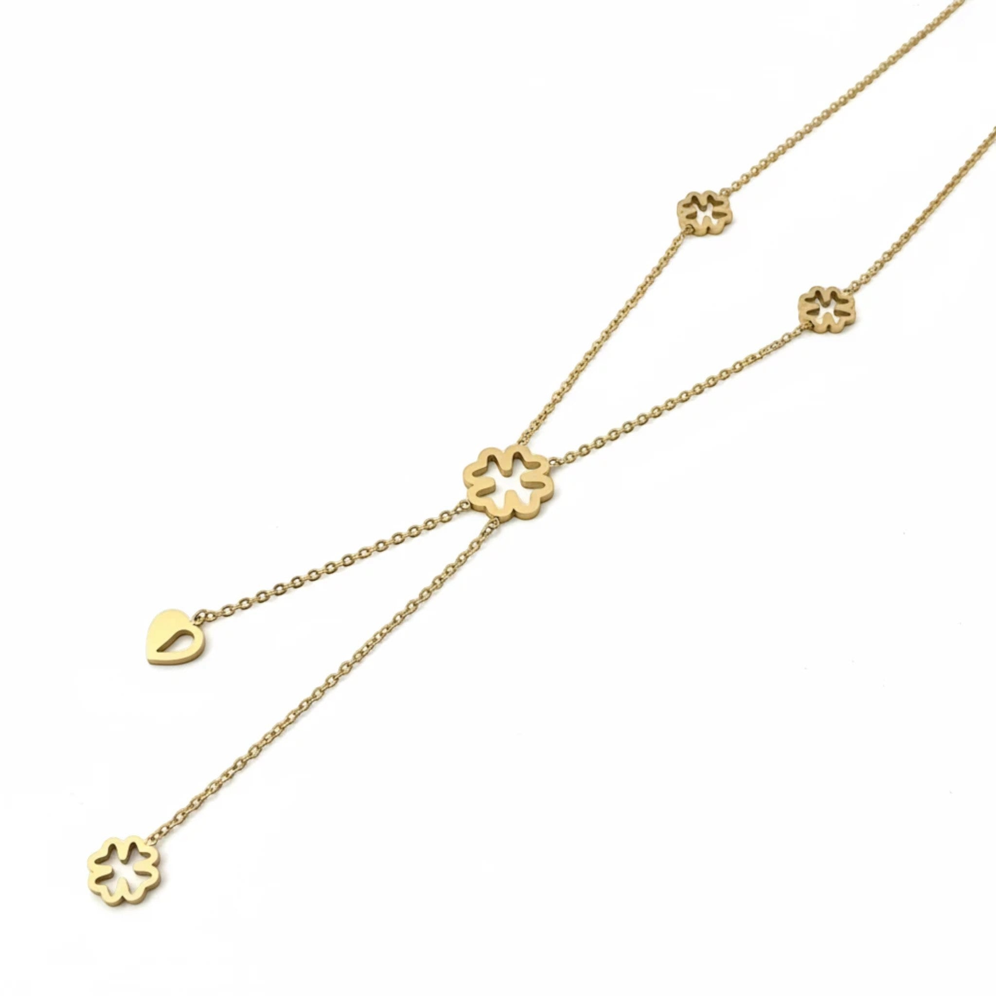 MiRA halsband i guldton med dekorativa blomdetaljer och hjärtberlock på en justerbar kedja.