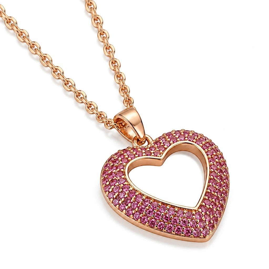 MiRA halsband i guldpläterat rostfritt stål med hjärtformat hänge prytt av små rosa stenar.