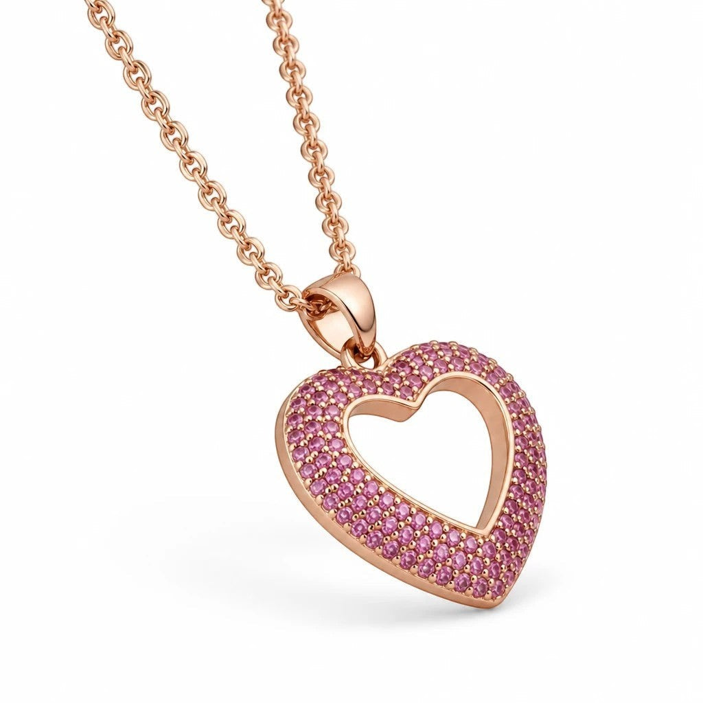 MiRA halsband i guldfärgat rostfritt stål med hjärtformat hänge prytt med små rosa stenar