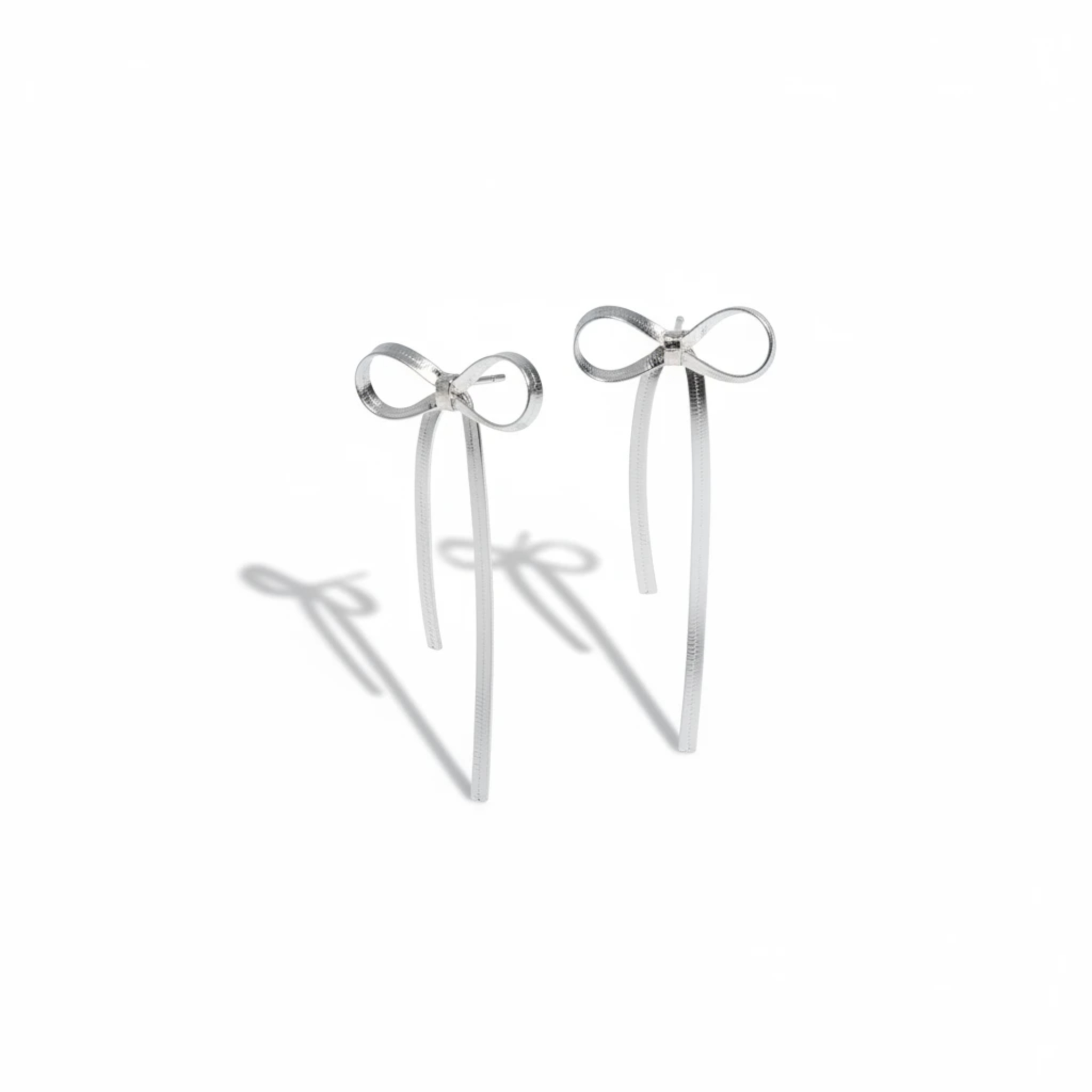 MiRA örhängen i rostfritt stål med elegant rosettdesign och hängande detaljer i silverfärg.
